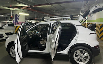 Private car for Sapa to Ha Giang City transfer with open doors in a parking garage.