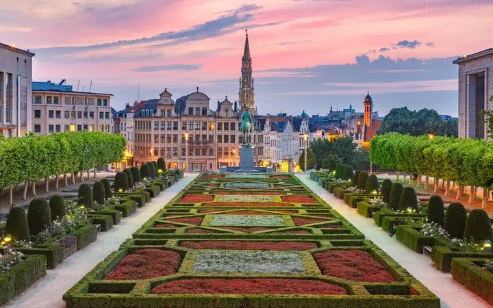 Mont des Arts garden with Brussels skyline at sunset during self-guided walking tour.