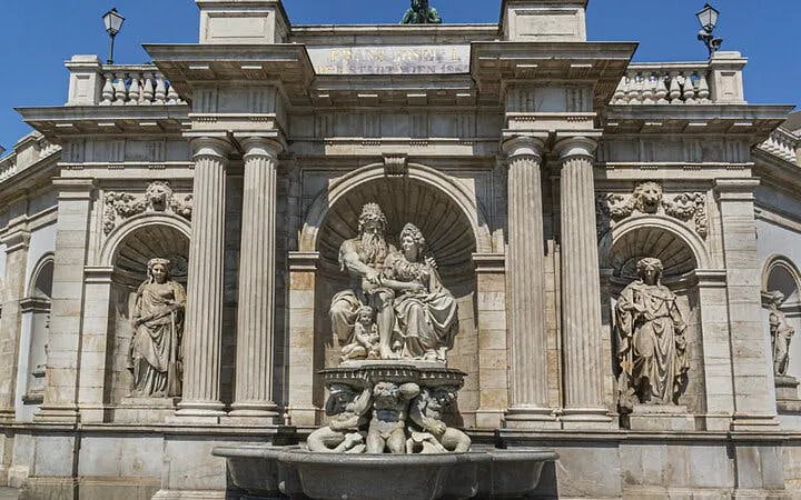 Vienna architectural landmark with statues, part of self-guided city exploration game.