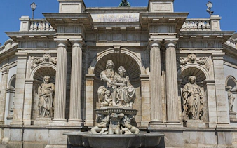 Vienna architectural landmark with statues, part of self-guided city exploration game.