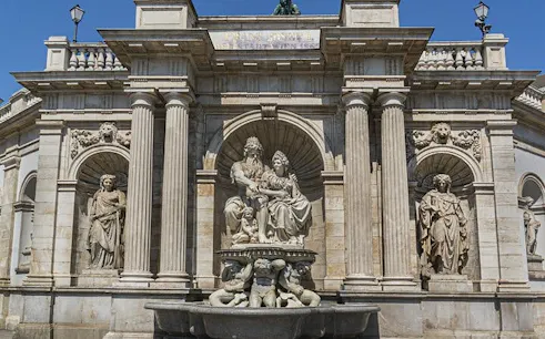 Vienna architectural landmark with statues, part of self-guided city exploration game.