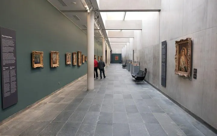 Musée de l'Orangerie gallery with visitors viewing paintings on display.