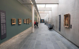 Musée de l'Orangerie gallery with visitors viewing paintings on display.