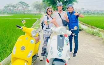 Tourists on Vespas in Hanoi countryside near Co Loa Citadel.