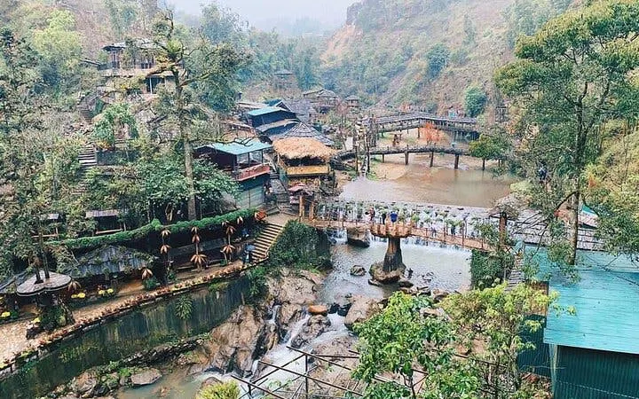 Sapa village landscape with bridges, waterfalls, and traditional houses on a motorbike sightseeing tour.