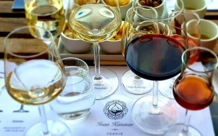 Wine glasses with various wines and food pairings at Krk Island winery cellar tour.