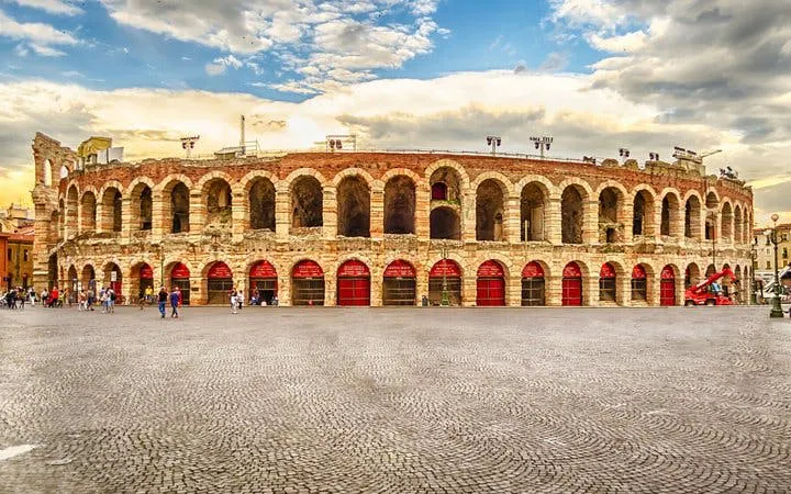 Verona Arena amphitheater under a cloudy sky, part of a self-guided walking tour.