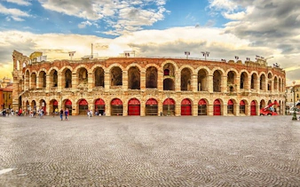 Verona Arena amphitheater under a cloudy sky, part of a self-guided walking tour.