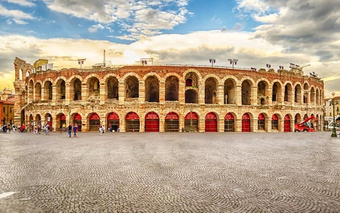 Verona Arena amphitheater under a cloudy sky, part of a self-guided walking tour.