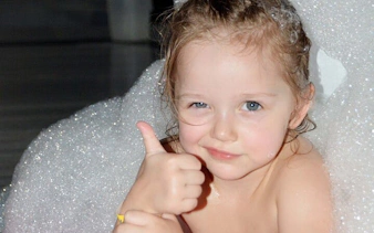 Child enjoying bubble bath at Turkish spa in Hurghada.