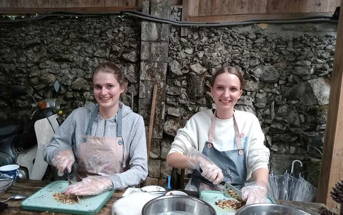 Participants chopping ingredients at a Pho noodle soup cooking class.
