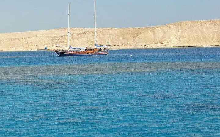 Sailing boat near Tiran Island with clear blue water, Sharm El Sheikh snorkeling trip.