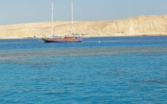 Sailing boat near Tiran Island with clear blue water, Sharm El Sheikh snorkeling trip.