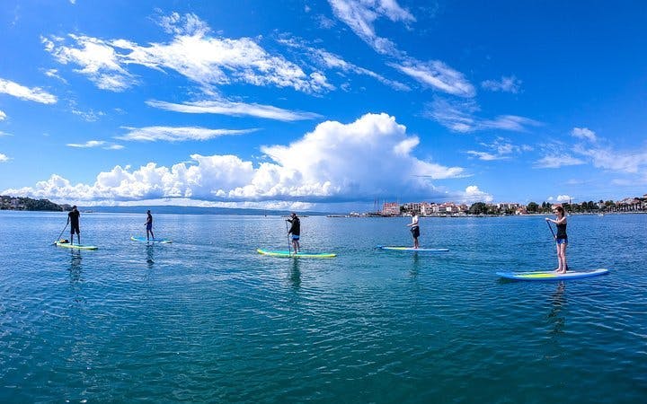 split stand-up paddleboarding tour across sea, river, and mountain landscapes-1