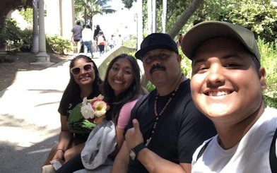 Group enjoying a sunny day at Balboa Park, San Diego, during a self-guided city exploration game.