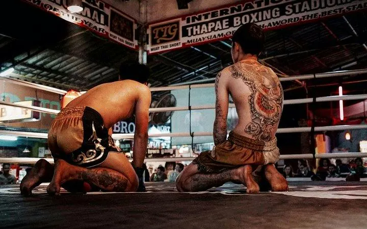 Muay Thai fighters kneeling in Thapae Stadium ring, Chiang Mai.