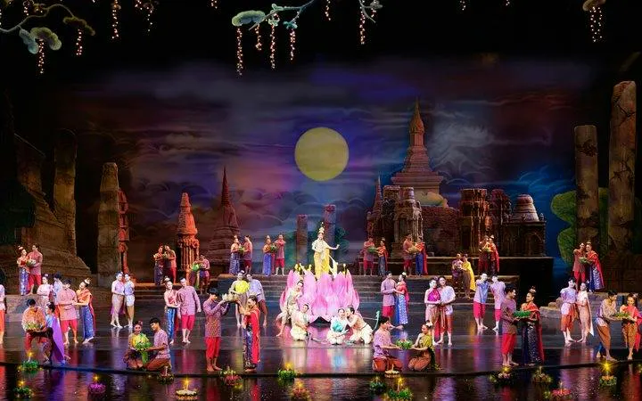 Performers on stage at Siam Niramit Phuket, depicting Thai cultural scenes with traditional costumes.