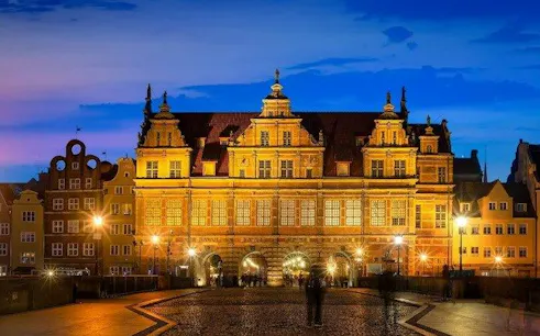Gdansk's Golden Gate illuminated at dusk during self-guided audio walking tour.