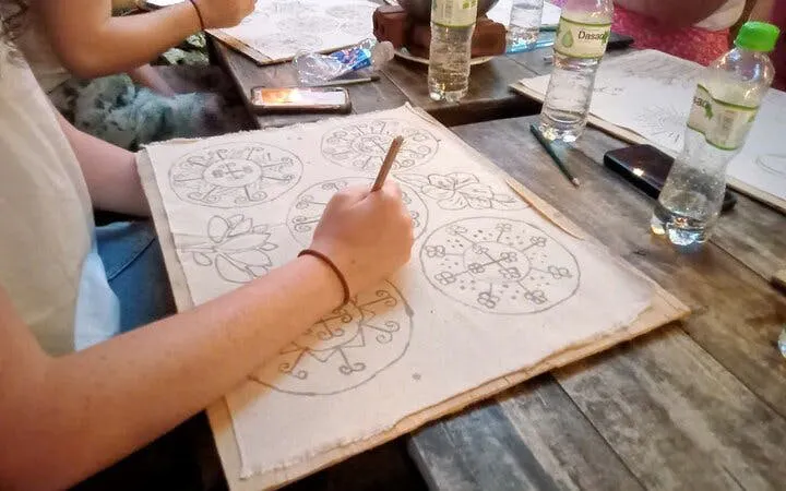 H’Mong artisan creating batik designs with beeswax in Sa Pa workshop.