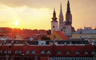Zagreb skyline with Zagreb Cathedral and Church of St. Mark at sunset.