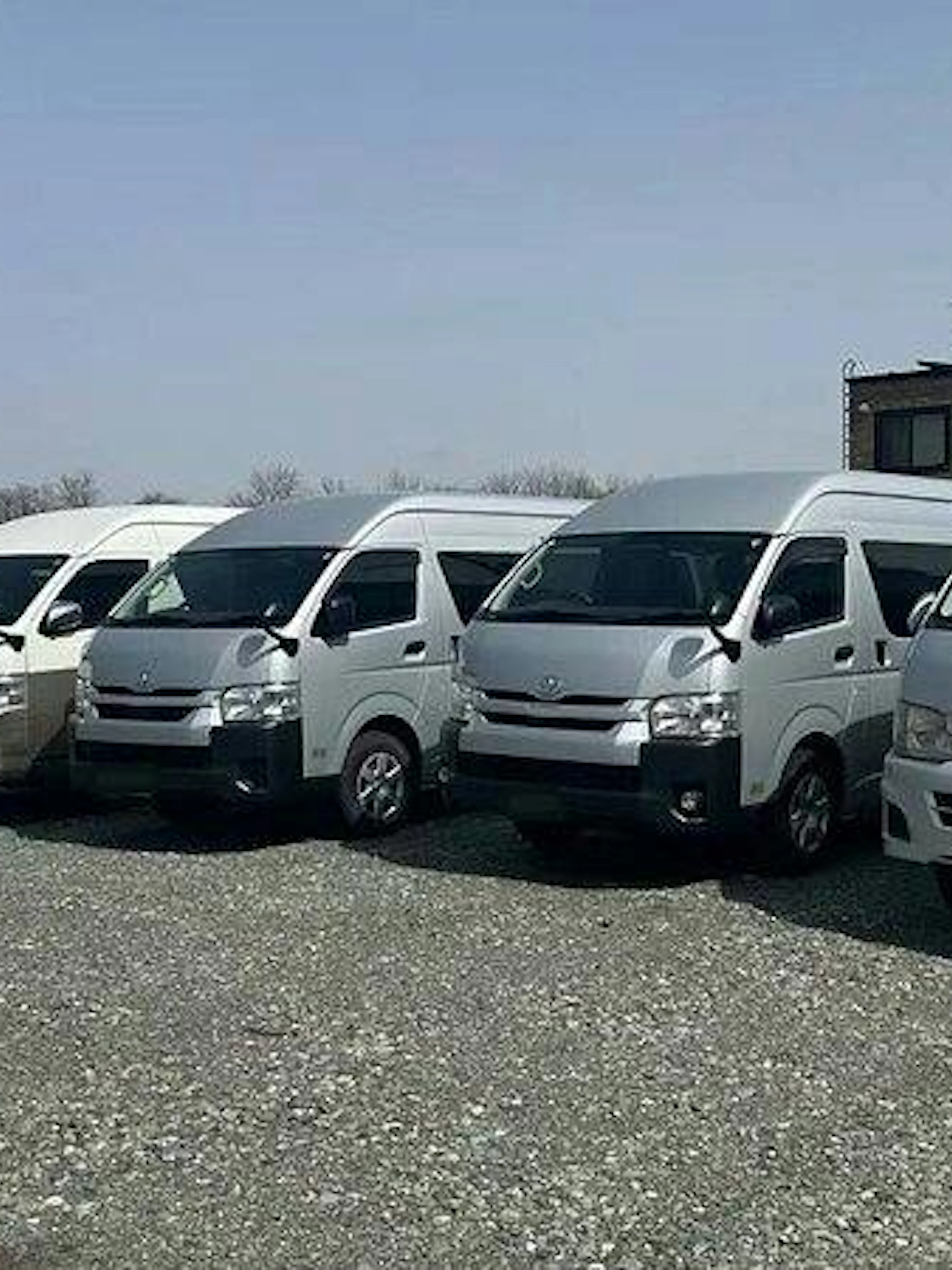 Private transfer vans parked for Fukuoka Airport to Fukuoka City service.