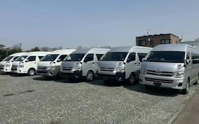 Private transfer vans parked for Fukuoka Airport to Fukuoka City service.