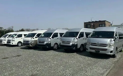 Private transfer vans parked for Fukuoka Airport to Fukuoka City service.
