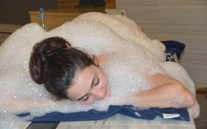 Person enjoying foam massage in Turkish bath, Hurghada.