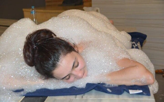 Person enjoying foam massage in Turkish bath, Hurghada.