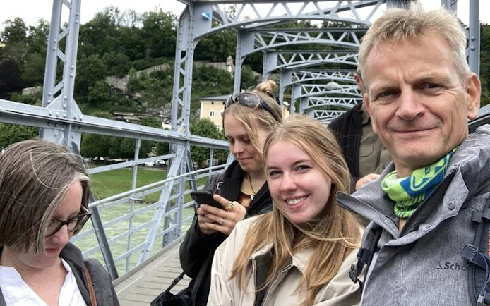 Group exploring Mozart's Salzburg on a bridge during a self-guided city game.