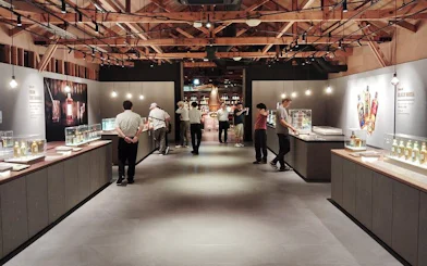 Yoichi distillery visitors exploring whisky exhibits at Nikka’s historic coastal site.