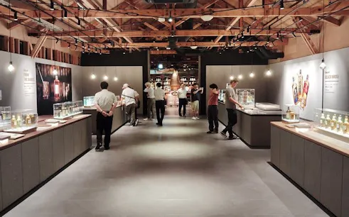 Yoichi distillery visitors exploring whisky exhibits at Nikka’s historic coastal site.