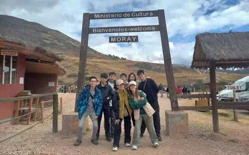Group at Moray archaeological site entrance, Sacred Valley day trip, Cusco.
