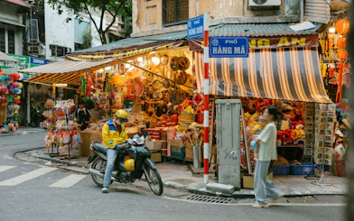 Street vendor with colorful lanterns and decorations in Hanoi Old Quarter, Vietnam.