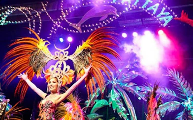Performer in vibrant costume on stage at Tiffany's Cabaret Show, Pattaya.