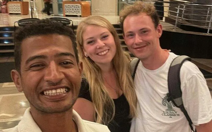 Tourists smiling with guide during private tour in Hurghada shopping area.