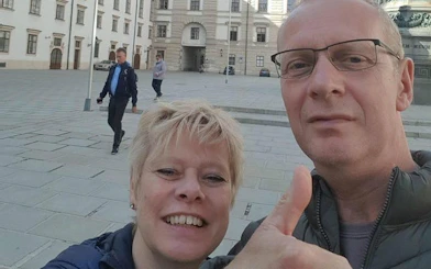 Self-guided tour participants in a Vienna square, exploring medieval plague history.