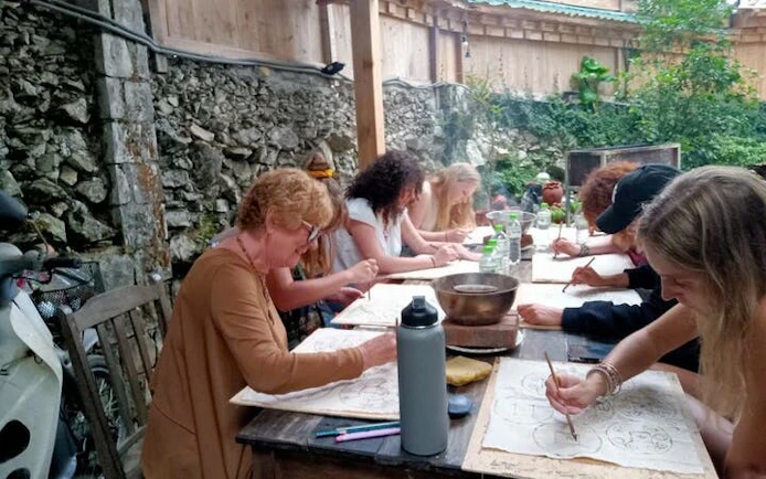 Participants creating batik art with beeswax at a workshop in Sa Pa, Vietnam.