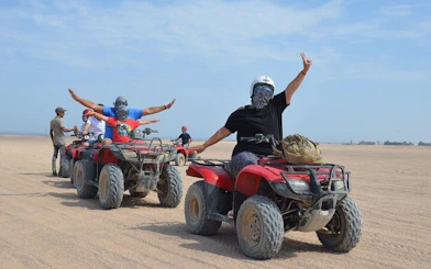 Quad bike riders in desert near Hurghada during safari tour.