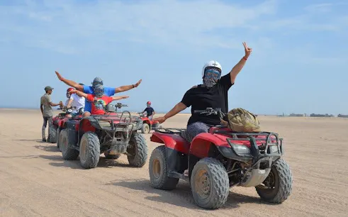 Quad bike riders in desert near Hurghada during safari tour.