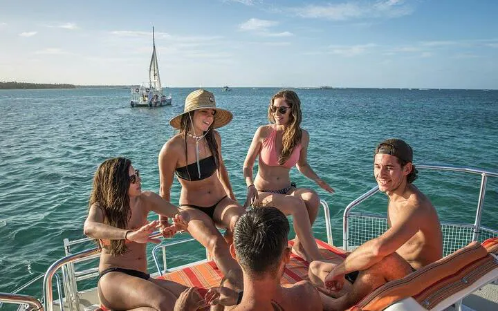 Group enjoying a catamaran cruise with drinks in Punta Cana's natural reserve.