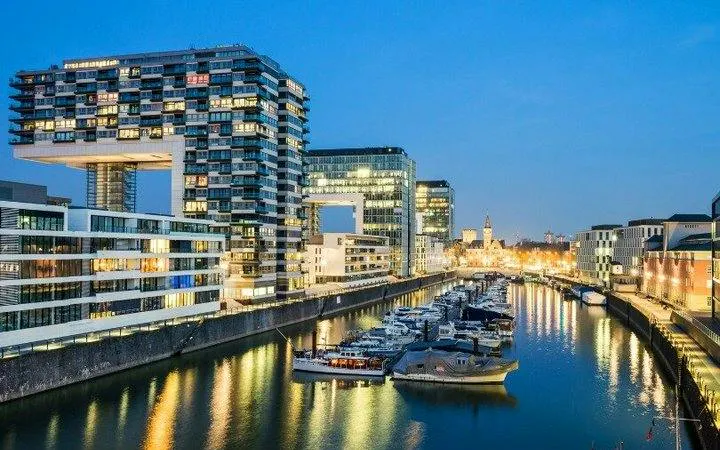 Kranhäuser buildings and marina at dusk in Cologne, Germany, featured in a self-guided walking tour.