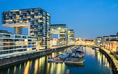 Kranhäuser buildings and marina at dusk in Cologne, Germany, featured in a self-guided walking tour.