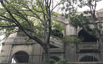 Historic Sydney building with arched windows and trees, part of Ghosts of Sydney exploration game.