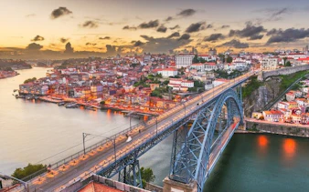 Porto cityscape with Dom Luís I Bridge at sunset, view from self-guided walking tour app.