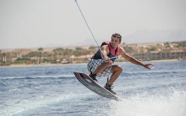 Water skiing in Sharm El Sheikh with view of coastline and mountains.