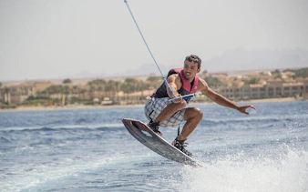 Water skiing in Sharm El Sheikh with view of coastline and mountains.