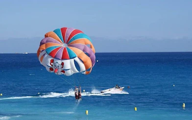 Parasailing over the Red Sea with a colorful parachute, speedboat in Hurghada.