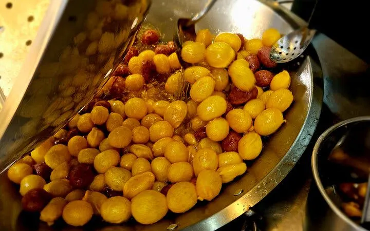 Stir-frying Taiwanese street food snacks in Taipei food tour.