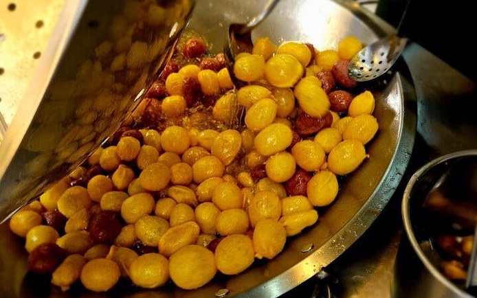Stir-frying Taiwanese street food snacks in Taipei food tour.